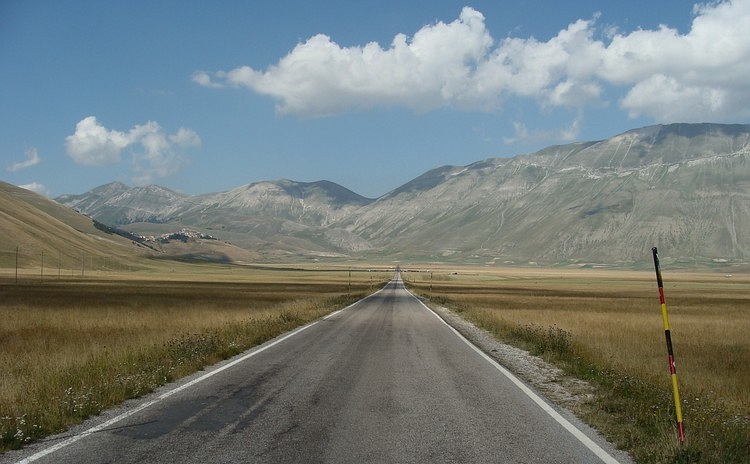 The road, the flatlands and the mountains. The Gran Piano and the Monti Sibillini, Umbria