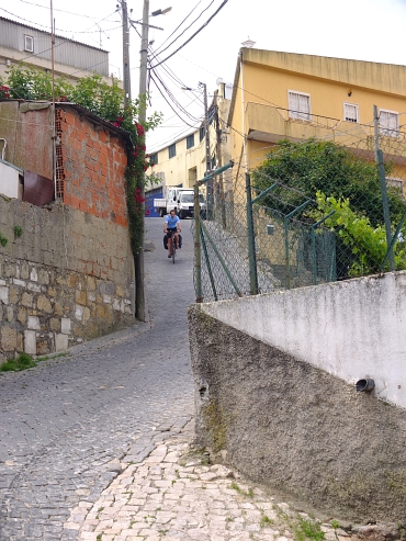 On an ultra steep cobblestone descent in an outskirt of Lisbon